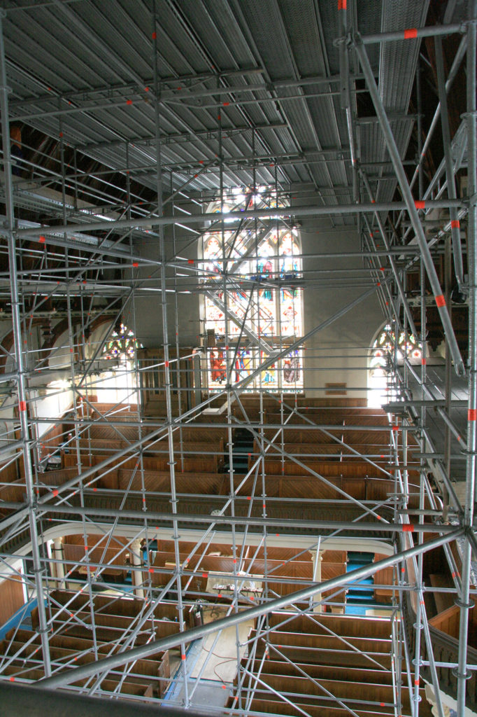 Birdcage high above church pews