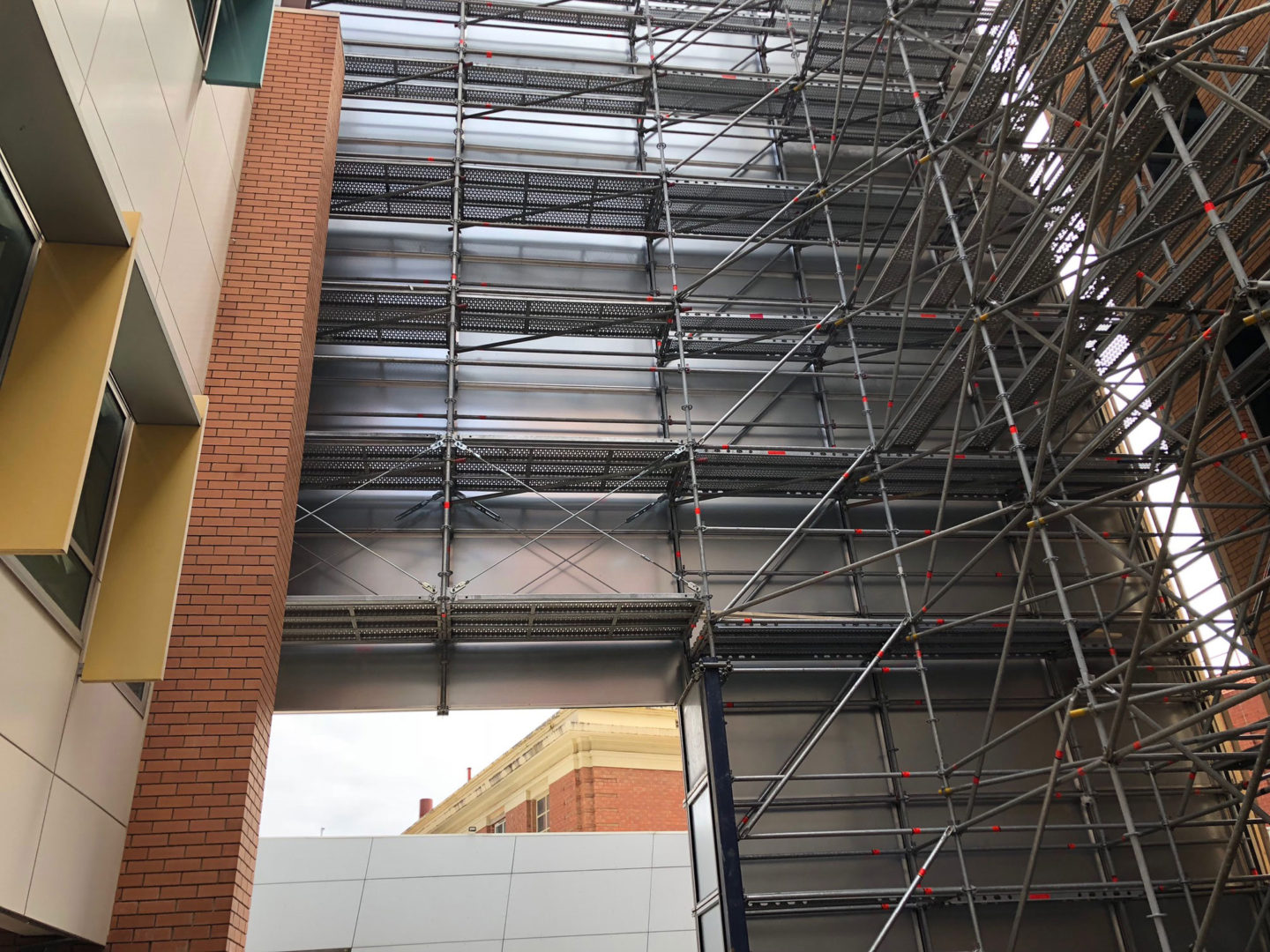 Scaffolding supporting protection panel containment system