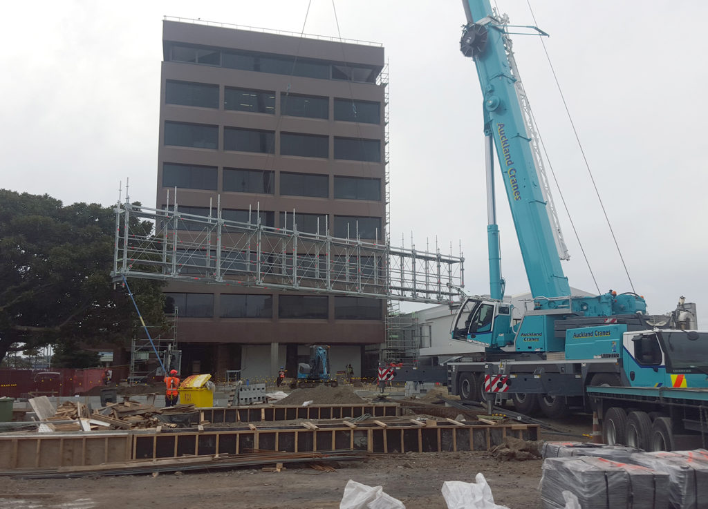 Layher Allround Bridging System being craned into position on top of heavy duty scaffold columns