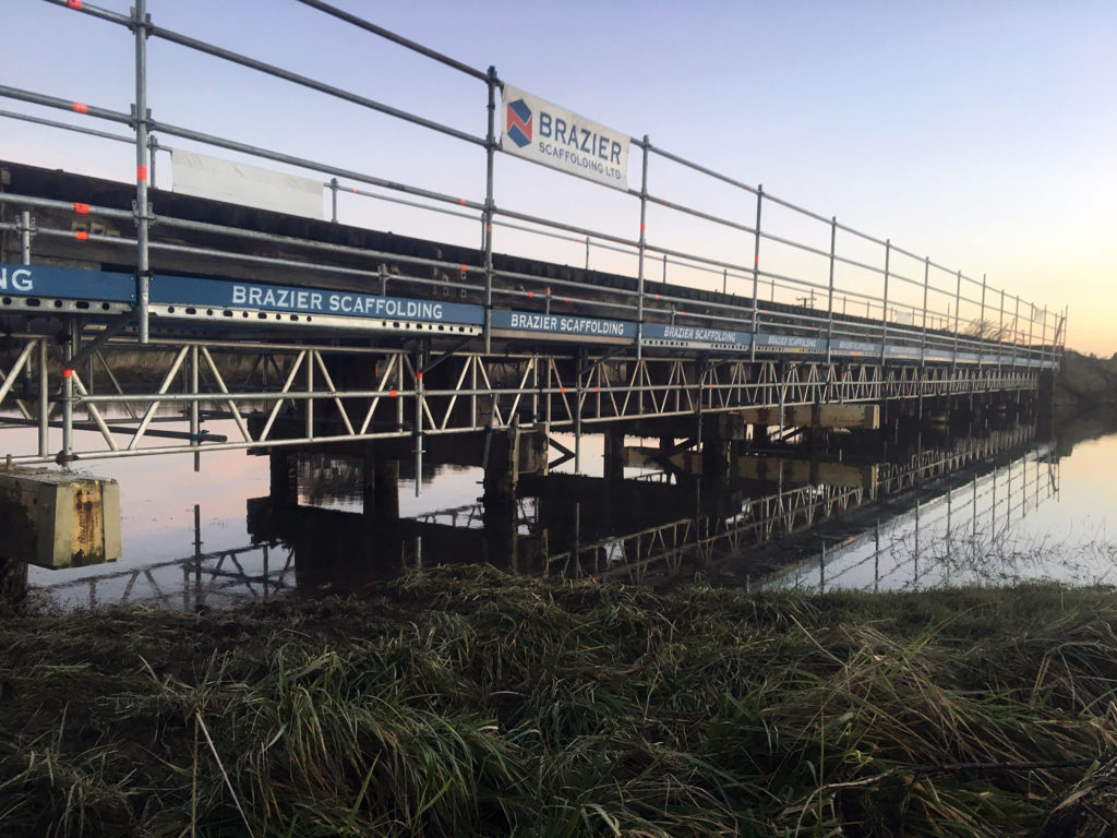 Brazier Scaffolding provided a Layher Allround working platform along an Invercargill rail bridge for Kiwi Rail